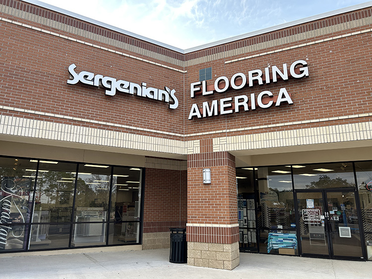 woman looking at flooring samples in a showroom with flooring expert