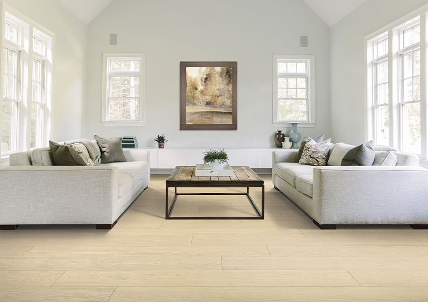 light hardwood flooring in living room with two gray couches